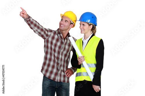 Photo: Architect and builder pointing into blank copyspace Architect and builder pointing into blank copyspace