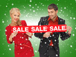 man and woman with sale sign