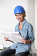 Female architect looking at plans
