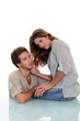 Young couple sat on glass desk