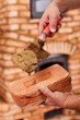 Building a masonry heater - closeup on worker hands