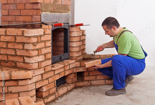 Photo: Worker building masonry heater Worker building masonry heater