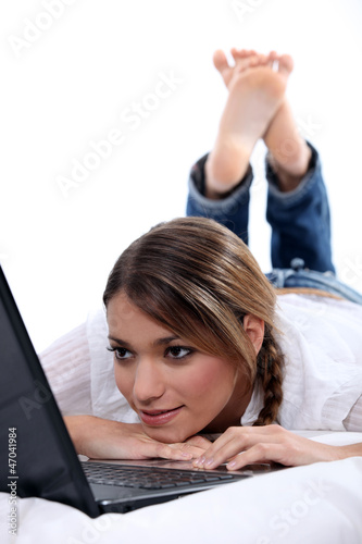 Photo: woman lying with computer woman lying with computer