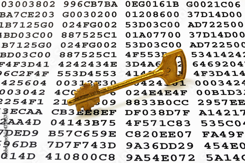 Photo: Golden key on a sheet with encrypted data Golden key on a sheet with encrypted data