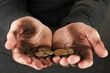 homeless man holding a coins, close-up