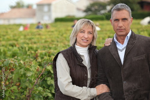 Photo: Couple in front of vineyard Couple in front of vineyard