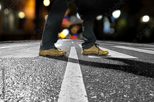 Photo: man crossing street at night man crossing street at night
