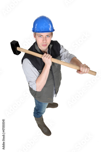Photo: Man wielding heavy hammer Man wielding heavy hammer