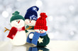 Photo: Family of snowmen with twinkling silver light background Family of snowmen with twinkling silver light background