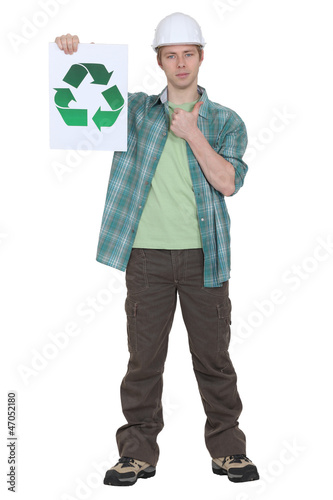 Photo: Man holding sign with recycling symbol Man holding sign with recycling symbol