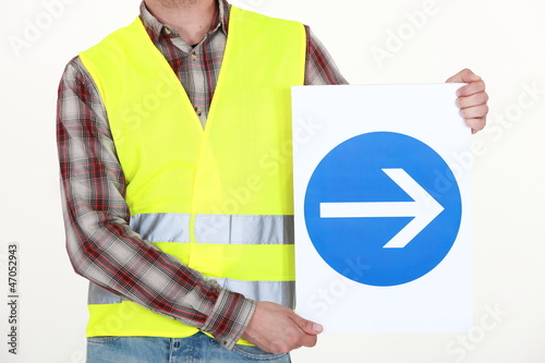 Photo: Man holding road sign Man holding road sign