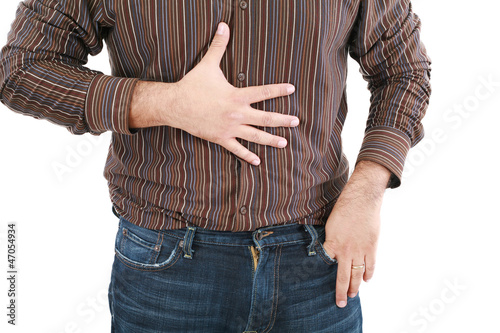 Photo: man holding his stomach in pain or indigestion man holding his stomach in pain or indigestion