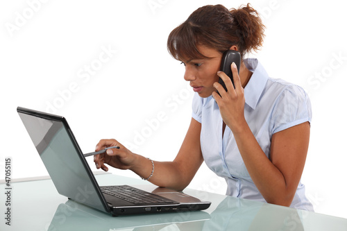 Photo: Woman telephoning technical help desk Woman telephoning technical help desk