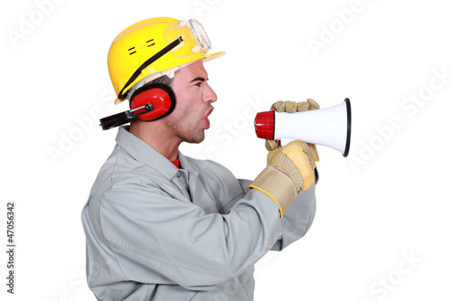 Photo: Manual worker shouting into megaphone Manual worker shouting into megaphone
