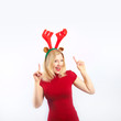 Foto: beautiful blonde woman with reindeer antlers is smiling beautiful blonde woman with reindeer antlers is smiling