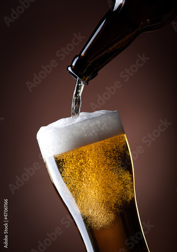 Photo: beer glass and bottle on a brown beer glass and bottle on a brown