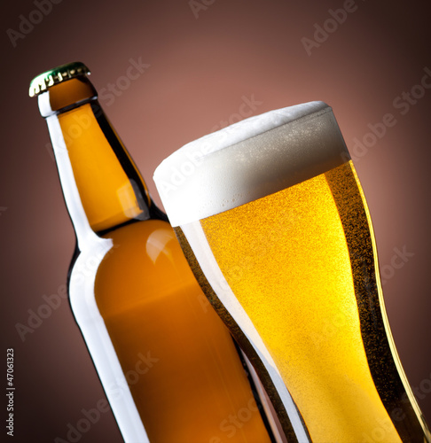Photo: beer glass and bottle on a brown beer glass and bottle on a brown