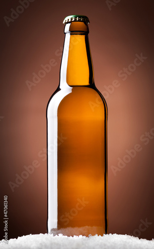 Photo: bottle of beer on a brown bottle of beer on a brown