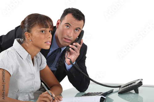 Photo: Man with telephone and note pad Man with telephone and note pad
