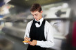 young waiter in work uniformon the white