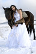Bride with a horse in the snow