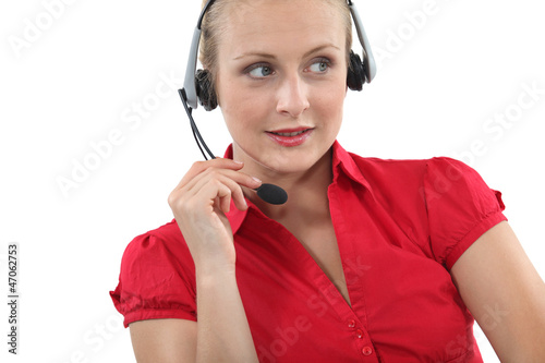 Photo: Blond receptionist using telephone head-set Blond receptionist using telephone head-set