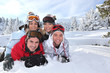 Young people lying in the snow