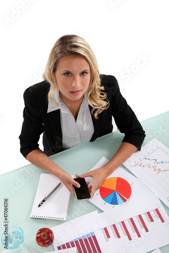Photo: Woman examining charts Woman examining charts