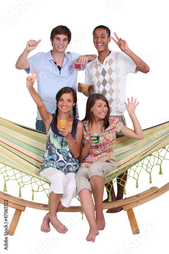 Photo: Young friends around a hammock Young friends around a hammock