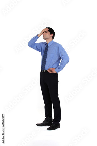 Photo: portrait of young businessman having remorse portrait of young businessman having remorse