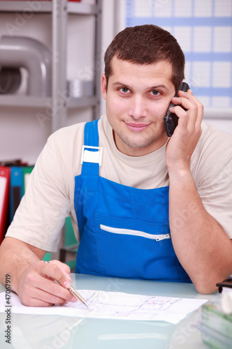 Photo: Technician on phone in office Technician on phone in office