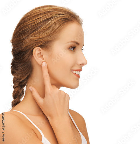 Photo: woman pointing to ear woman pointing to ear