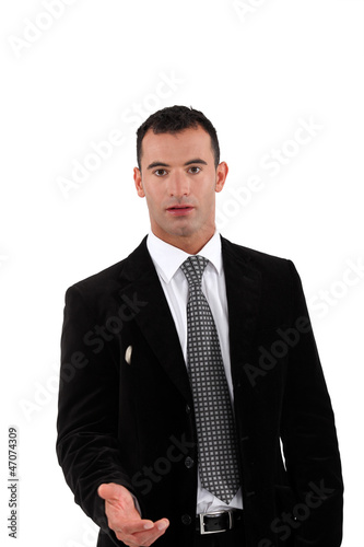 Photo: Businessman offering you his hand Businessman offering you his hand