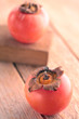 Persimmons on rustic wood