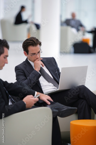 Photo: Businessmen waiting in airport lounge Businessmen waiting in airport lounge