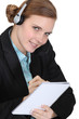 Receptionist writing in a notebook