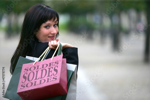 Photo: Young woman carrying her shopping bags Young woman carrying her shopping bags
