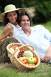 Couple posing with a fruit basket