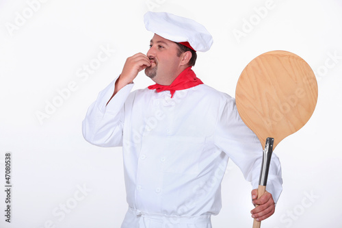 Photo: Pizza chef with a wooden peel Pizza chef with a wooden peel