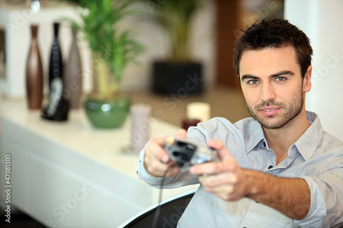 Photo: Man playing a video game Man playing a video game