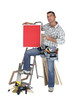 Carpenter proudly standing by equipment