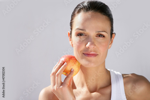 Photo: Woman with apple in hand Woman with apple in hand