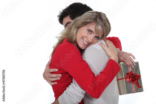 Photo: husband giving her wife a present husband giving her wife a present