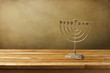 Menorah on wooden table. Hanukkah holiday symbol.