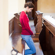 Young woman praying in a church