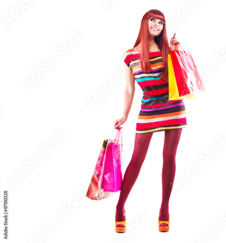 Photo: Fashion Shopping Girl. Woman with Shopping Bags over White Fashion Shopping Girl. Woman with Shopping Bags over White