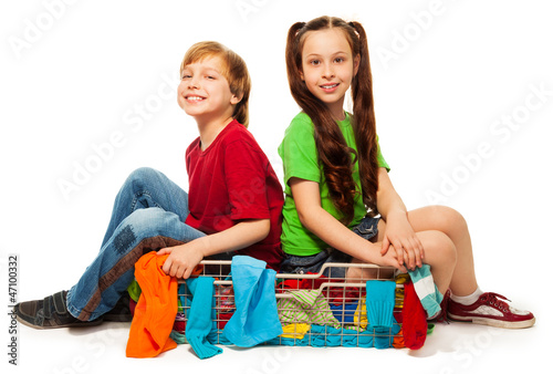 Photo: two kids in clothing basket two kids in clothing basket