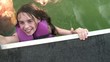 Girl Smiling Tries to Get Into Boat