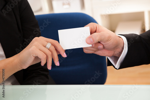 Photo: Man handing over a business card Man handing over a business card