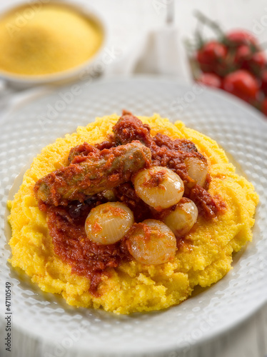 Photo: porridge with sausage and tomatoes sauce, selective focus porridge with sausage and tomatoes sauce, selective focus